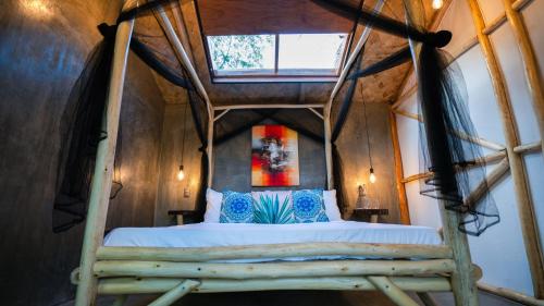 a bedroom with a bed in a tree house at Carabao Lodge - 2 bedroom house, stargazing & pool in El Nido