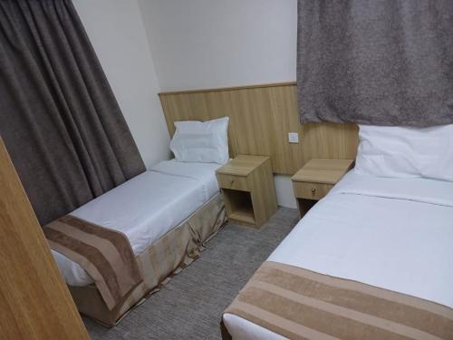 a hotel room with two beds and a window at فندق سما السماح Sama Al Samah Hotel in Makkah