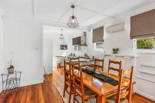 a dining room and kitchen with a table and chairs at Central and Affordable - Cute Art Deco in Gisborne