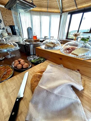 a kitchen with a table with food and a knife at B&B Eyexei Domus in Agrigento