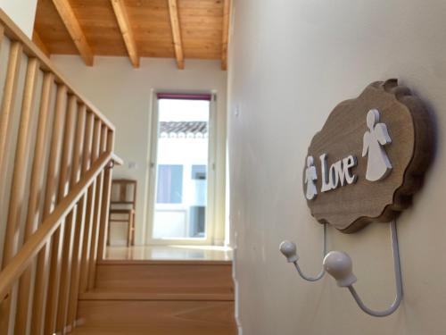 a sign on the wall of a room with a staircase at Estudio Hortas in Vila do Bispo