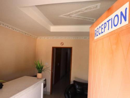 an office with a sign that reads propagationvention on a wall at Amariah Guest House in Kasane