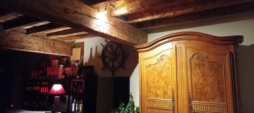 a wooden cabinet in the corner of a room at Domaine Le Clos du Figuier Spa Grisolles in Verdun-sur-Garonne