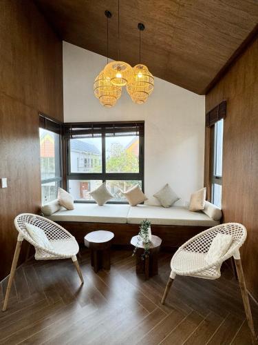 a living room with a couch and two chairs at Tropicana Hồ Tràm - Seashell Villa in Ho Tram