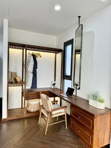a room with a desk and a mirror at Tropicana Hồ Tràm - Seashell Villa in Ho Tram
