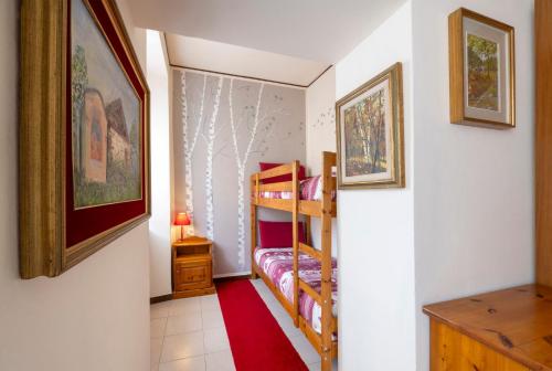 a small room with two bunk beds and a red carpet at Bed & Breakfast Tiffany in Domodossola