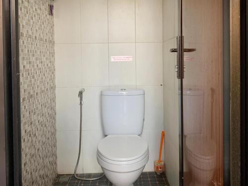 a bathroom with a white toilet and a shower at Villa Dengan Kolam Renang di Malang in Malang