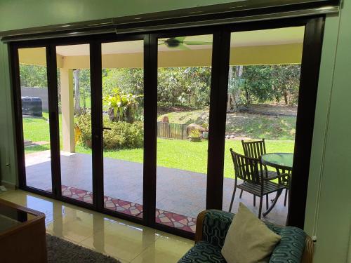 a screened in porch with a view of a patio at Teratak D Tuntung, Hulu Langat in Kampong Mesjid