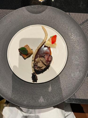 a plate with a dessert on a table at PINOKKIO B&B Restaurant in Jimbaran