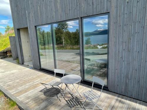 a group of chairs and a table on a deck at Villa Northern Light in Tromsø