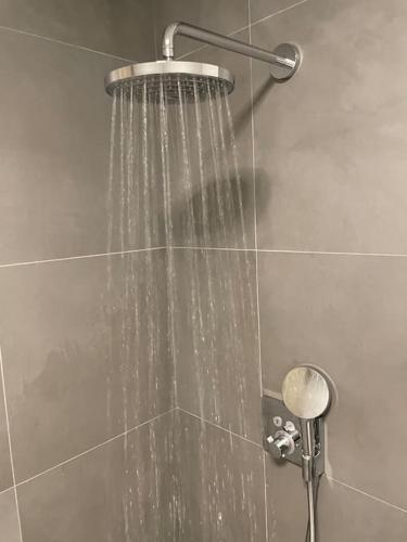 a shower with streams of water in a bathroom at Villa Northern Light in Tromsø