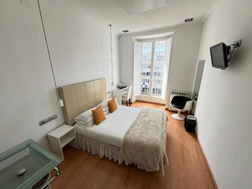 Postel nebo postele na pokoji v ubytování Hostal Santo Domingo