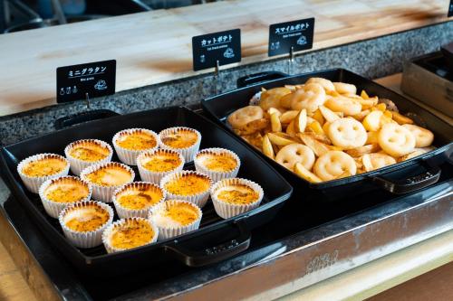 a tray of cupcakes and pretzels on a counter at Nara Plaza Hotel in Tenri