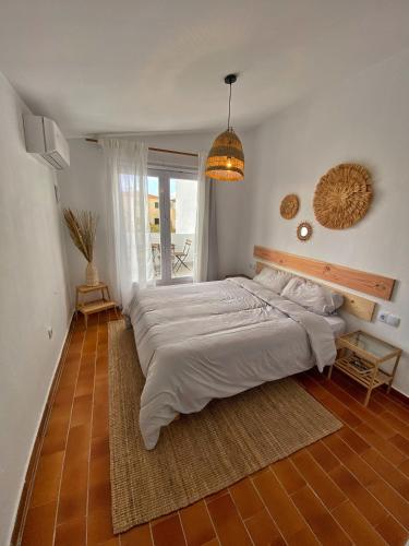 a large bedroom with two beds and a pendant light at Villa Calma 450m from the beach in Cala en Blanes