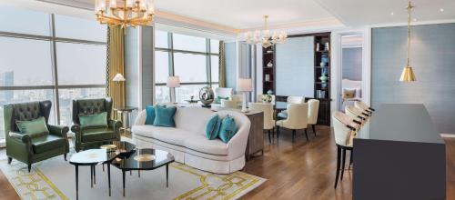 a living room with a couch and chairs and a table at The St. Regis Shanghai Jingan in Shanghai