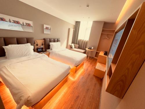 Ένα ή περισσότερα κρεβάτια σε δωμάτιο στο True Go Hotel - Beijing Asian Games Village National Convention Center