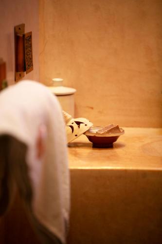 a nun standing on a counter with a bowl on it at Riad Alili in Marrakech