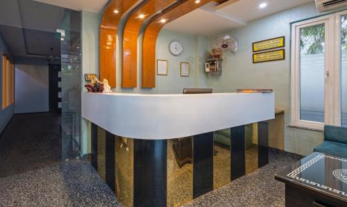 a lobby with a white counter in a room at Treebo Shakuntalam, Near Lucknow Airport in Lucknow