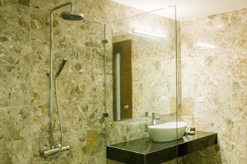 a bathroom with a sink and a glass shower at FLAMIGO Đại Lải - Villa Tự Doanh in Phúc Yên