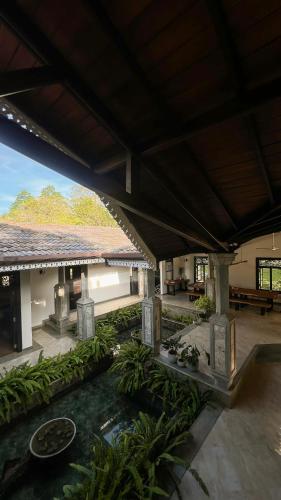 a large building with a courtyard with plants andestones at Roots Retreat in Unawatuna