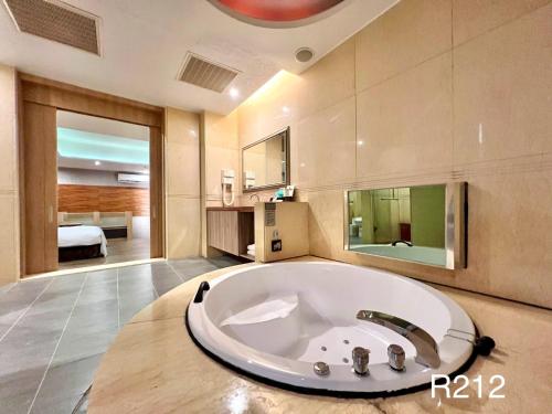 a large bathroom with a large tub in a room at Cigar Motel in Tainan