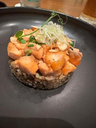 a dish of food on a black plate at PINOKKIO B&B Restaurant in Jimbaran