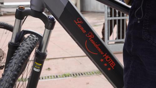 a bike with an orange writing on the front tire at Luna Residence Hotel in Casalmaggiore