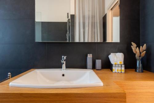a bathroom with a white sink on a wooden counter at Villa Marcello in Cagliari