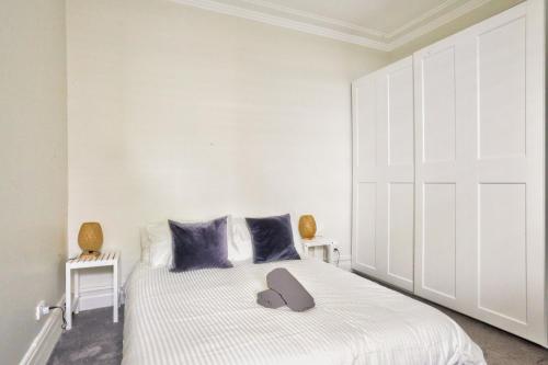 a bedroom with a large white bed with blue pillows at Unique 2 Bedroom Darling Harbour Glebe 2 E-Bikes Included in Sydney