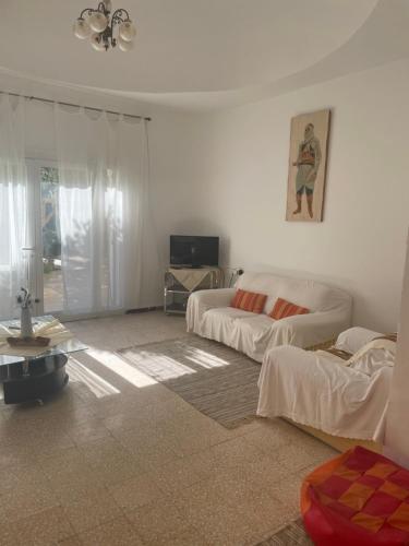 a living room with two beds and a couch at Dar dguech in Degache