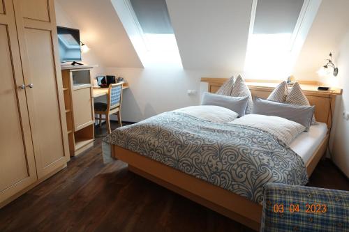 a bedroom with a bed and a desk and a kitchen at Pension Haus Sanz in Vienna