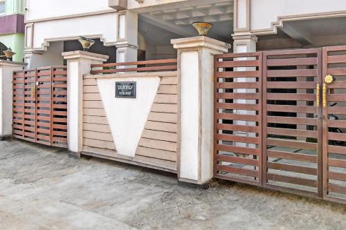 a row of wooden fences in front of a house at Hotel O Regal Stays in Khandagiri