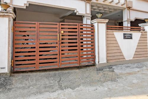 a wooden gate in front of a house at Hotel O Regal Stays in Khandagiri