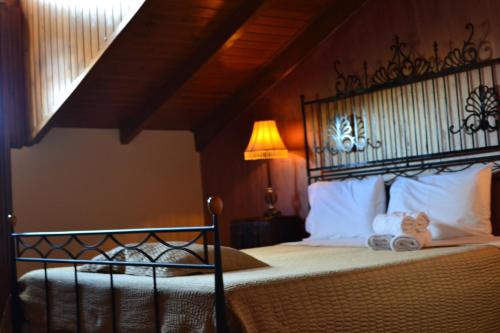 a bedroom with a bed with a wrought iron headboard at Pension Anapli in Nafplio