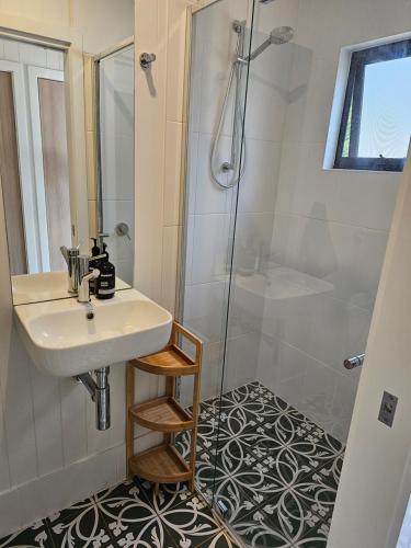 a bathroom with a sink and a shower at Winterlude Cottage in Orange