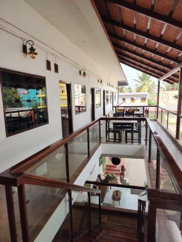 a balcony of a building with tables and chairs at Seed Resort in Shrīrangapattana