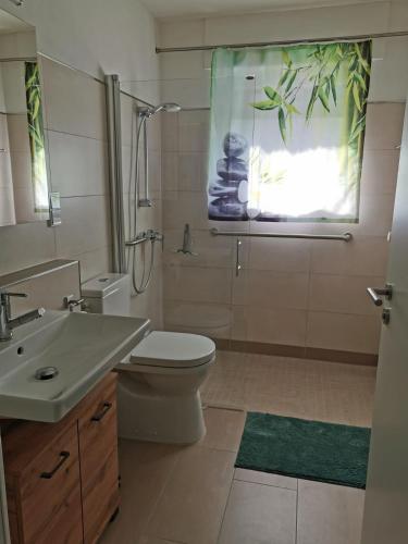 a bathroom with a sink toilet and a shower at Ferienwohnung Hedi in Konz