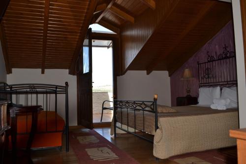a bedroom with a bed with a wooden ceiling at Pension Anapli in Nafplio