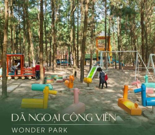 a playground in a park with people playing at FLAMIGO Đại Lải - Villa Tự Doanh in Phúc Yên
