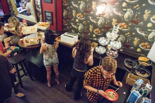 a group of people eating food in a restaurant at Flying Pig Downtown in Amsterdam