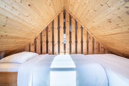 a bedroom with a large bed in a wooden ceiling at Hotel Viking in Hafnarfjördur