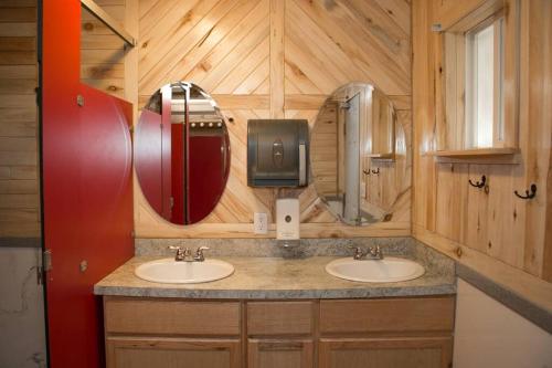 a bathroom with two sinks and two mirrors at Moab RV Resort Glamping Setup Tent in RV Park #2 OK-T2 in Moab