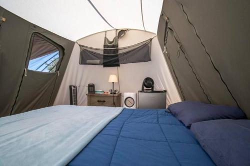 a bedroom with a bed in a tent at Moab RV Resort Glamping Setup Tent in RV Park #2 OK-T2 in Moab