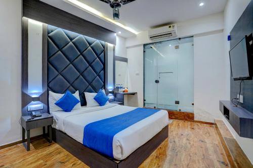a bedroom with a large bed and a shower at Hotel Gorrion in Mumbai