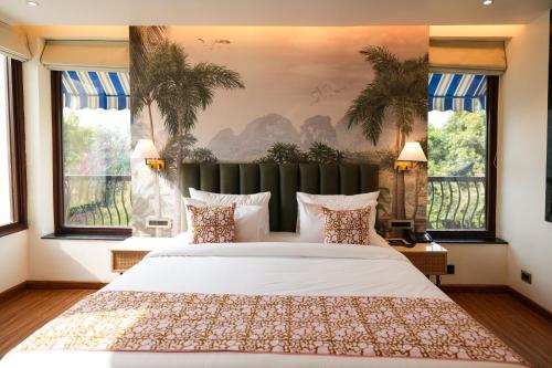 a bedroom with a large white bed and windows at The LIV Hotel Jaipur in Jaipur