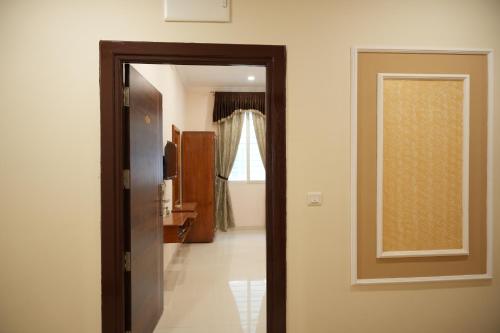 a door leading into a room with a hallway at SABA SERVICE APARTMERNT in Hyderabad