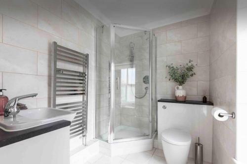 a bathroom with a shower and a toilet and a sink at 4 beds - 2 bathroom Apartment, New Oxford Street in London