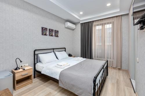 a bedroom with a bed and a window at Monument1880 in Tbilisi City