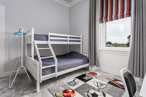 a bedroom with a bunk bed with a ladder at Castlehill Road in Ayr