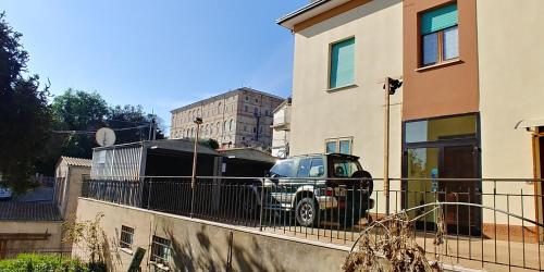 a car parked on a fence in front of a building at B&B Itala in Recanati